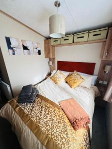 a bedroom with a large bed in a room at Princess's Palace, Holiday Lodge, Malvern View Leisure Park in Stanford Bishop
