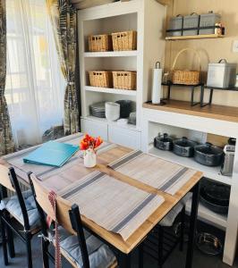 a dining room with a table and chairs and shelves at Princess's Palace, Holiday Lodge, Malvern View Leisure Park in Stanford Bishop