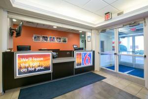 a waiting room with a sign in a building at Motel 6-Brooklyn Center, MN - Minneapolis in Brooklyn Center