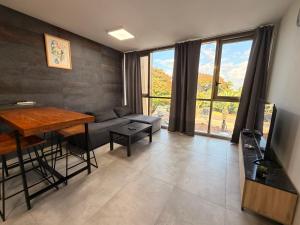 a living room with a couch and a table at The Caesar Stay in Caesarea