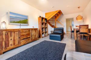 a living room with a staircase and a dining room at Haus Wittow in Breege