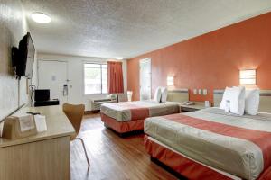 a hotel room with two beds and a television at Motel 6-Union City, GA - Atlanta Airport in Union City
