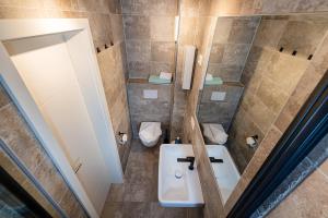 a bathroom with a sink and a toilet at Haus Wittow in Breege +18 photos