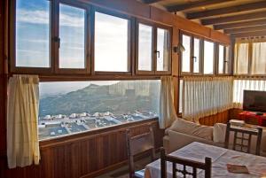 a room with a large window with a view at Camping Alpujarras in Laroles
