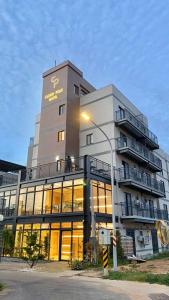 a large building with a sign on top of it at Yunfeng Hotel 雲峰精品文旅 in Jinning