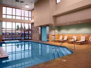 a pool in a hotel room with chairs and tables at Chukchansi Gold Resort & Casino in Coarsegold +18 photos