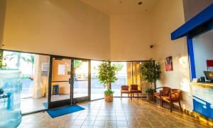 an empty lobby with chairs and plants in a building at Motel 6-Santa Nella, CA - Los Banos in Santa Nella Village