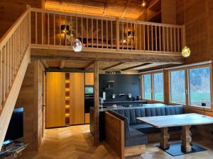 a living room with a blue couch and a table at Bocks Apartments 53C in Wald am Arlberg +28 photos