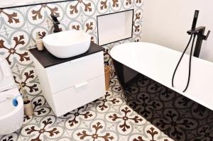 un bagno con un lavandino bianco e uno specchio di Pineview Lempes a Braşov Altre 25 foto