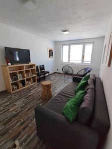 a living room with a couch and a tv at Apartmán Emma Volary in Volary