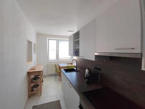 a kitchen with white cabinets and a counter top at Apartmán Emma Volary in Volary
