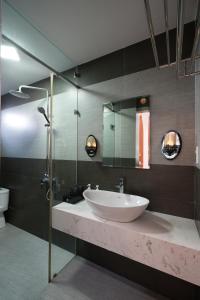 a bathroom with a sink and a glass shower at Nana Villa Hue in Hue +53 photos