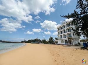a hotel on the beach in front of the ocean at Babylon Hotel Phu Quy in Cu Lao Thu