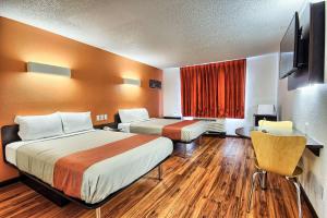a hotel room with two beds and a flat screen tv at Motel 6-Columbus, OH - West in Lincoln Village +49 photos