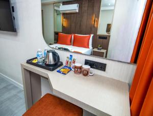 a hotel room with a bed and a mirror at Cosinüs Airport Hotel in Arnavutköy