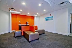 a waiting room with two chairs and a table at Motel 6-Miami, FL in Miami