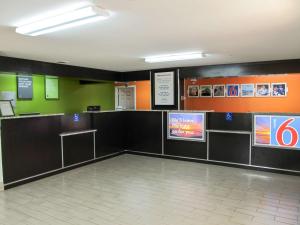 a waiting room with a counter and signs on the wall at Motel 6-Augusta, GA - Fort Gordon in Augusta