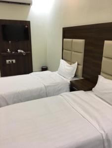 Postel nebo postele na pokoji v ubytování الذيابي للشقق المخدومة