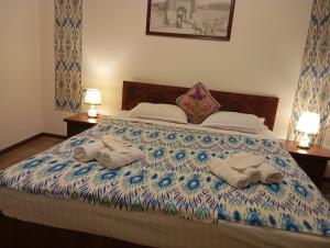 een bed met twee handdoeken erop bij Hotel Said with a Terrace Best Location in Bukhara