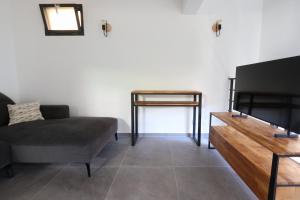 ein Wohnzimmer mit Sofa und Flachbildfernseher in der Unterkunft Nümad Suites in Nizza