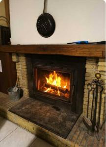 een stenen open haard met een vuur erin bij La Caminada in Fougax-et-Barrineuf