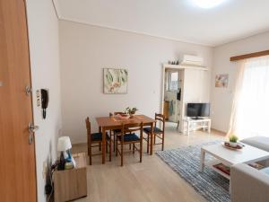 a living room and dining room with a table and chairs at DaMa Blue in Saronida