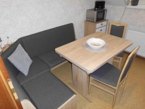 a couch and a table with a bowl on it at Ferienwohnung Windten in Braunlage