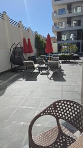 a row of chairs and umbrellas on a patio at 2 Bedroom Duplex - Hurghada in Hurghada