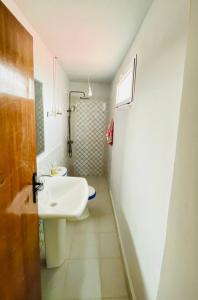 a white bathroom with a sink and a toilet at Boulemane guest house in Boulmane