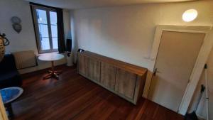 a living room with a wooden door and a table at Harfleur Studio in Harfleur