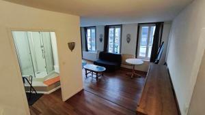 a living room with a couch and a table at Harfleur Studio in Harfleur