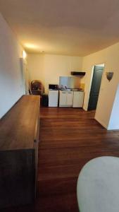 a room with a kitchen with a wooden floor at Harfleur Studio in Harfleur