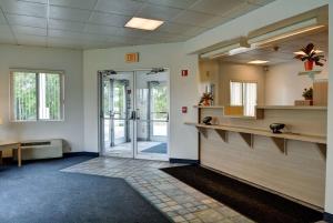 an empty waiting room with a glass door at Motel 6-Warwick, RI - Providence Airport - I-95 in Warwick