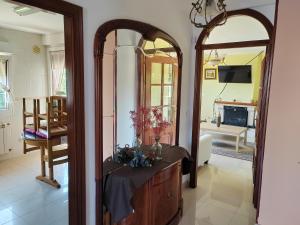 a living room with a large mirror and a dresser at Casa Seán in Boiro