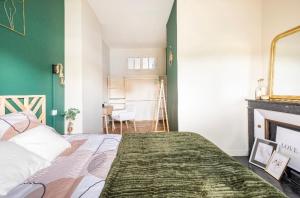 a bedroom with a bed and a green wall at L'Authentique Free parking in Mâcon +3 photos