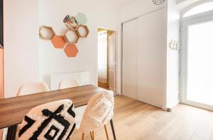 a dining room with a wooden table and chairs at L'Authentique Free parking in Mâcon