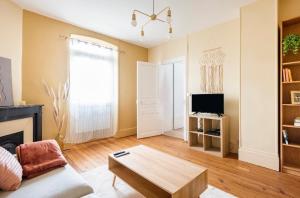a living room with a couch and a coffee table at L'Authentique Free parking in Mâcon