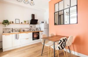 a kitchen with a table and chairs in a room at L'Authentique Free parking in Mâcon