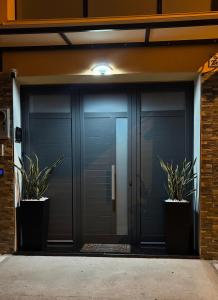 een paar glazen deuren met twee potplanten bij Il Vicoletto room in Mercato San Severino