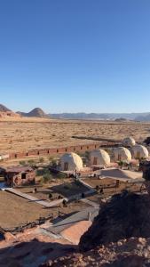 a group of domes in the middle of a desert at Ajyad Rum Camp in Wadi Rum