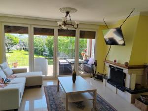 a living room with a couch and a fireplace at Casa Seán in Boiro