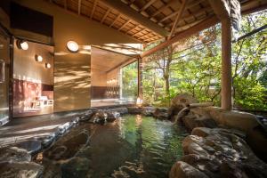 a pool of water in the middle of a house at 御宿竹林亭 in Takeo