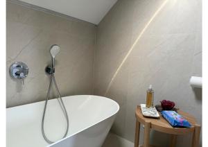 a bathroom with a white tub and a shower at Atelier K7 in Žilina