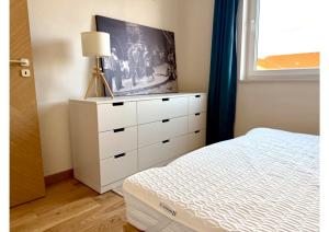 a bedroom with a white dresser with a tv on it at Atelier K7 in Žilina
