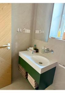 a bathroom with a white sink and a mirror at Atelier K7 in Žilina