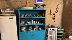 a blue cabinet filled with dishes and a stove at Byet ahalna in Mūsá +35 photos