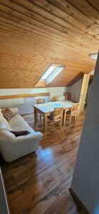 a living room with a table and chairs and a couch at Apartmány Sára in Tanvald