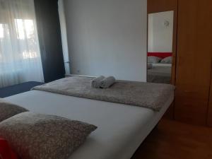 a bedroom with two beds and a mirror at CenterZeroZoneOne in Banja Luka
