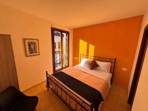 a bedroom with a bed and a window at Hotel Canal Salieri in Venice