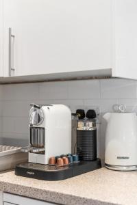 a kitchen counter with a coffee maker on a counter at Spacious - Central - King Beds - Fast Wi-Fi in Brighton & Hove